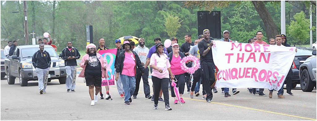 Members of the Grambling State University baseball team and the More Than Conquerors Breast Cancer Support Group march to raise awareness for breast cancer during the baseball team’s Pink Strike Out Breast Cancer walk on April 14. Photo by Glen Lewis.