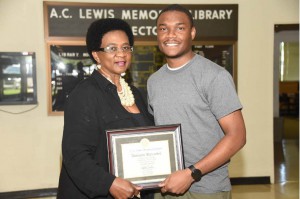 Library certificate presented to Mr. Alickson Alexander by Mrs. Glenda Wade.