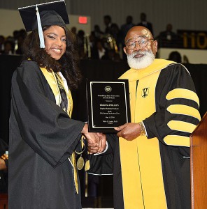 Brianna Phillips, GSU Valedictorian shaking hands with GSU President Willie D. Larkin