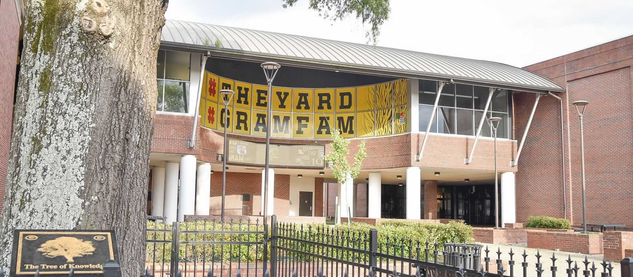 Photograph of a building on campus with a banner showing hashtags that say The Yard and Gram Fam.